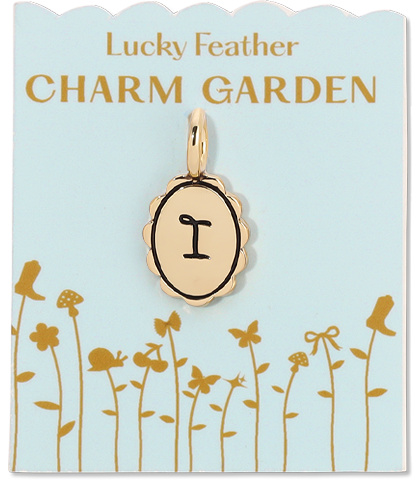 A gold letter 'I' charm hangs from a card labeled 'Lucky Feather CHARM GARDEN' with a flower and boot illustration.