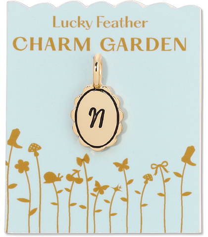 Gold charm with the letter 'n' on a card labeled 'Lucky Feather CHARM GARDEN'.