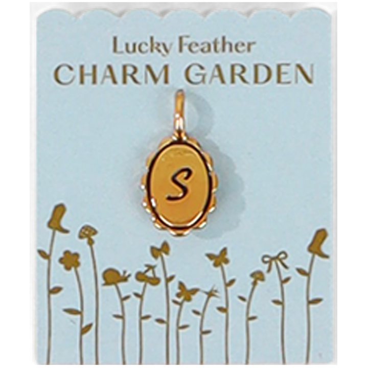 A gold charm pendant of the letter S hangs on a 'Lucky Feather Charm Garden' card.
