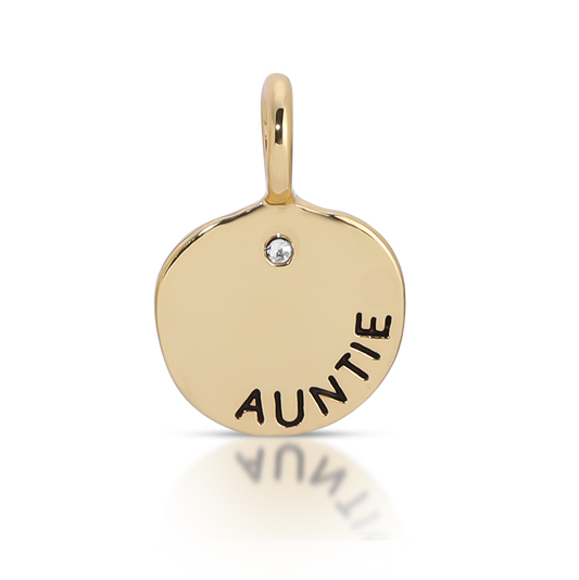 A gold charm pendant with 'AUNTIE' inscribed and a small stone.