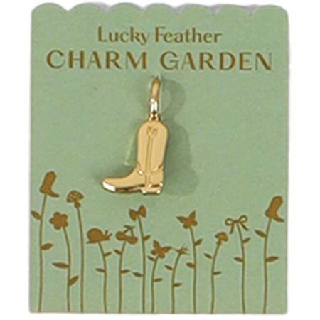 A golden cowboy boot charm hangs on a green card that says 'Lucky Feather CHARM GARDEN'.