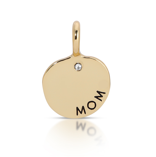 A gold charm with a loop at the top displays the word 'MOM' and a small clear gem.