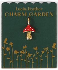 A mushroom charm on a 'Lucky Feather Charm Garden' card.