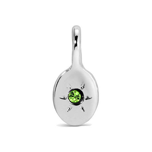 A silver pendant features a green gem in the center of a starburst design.
