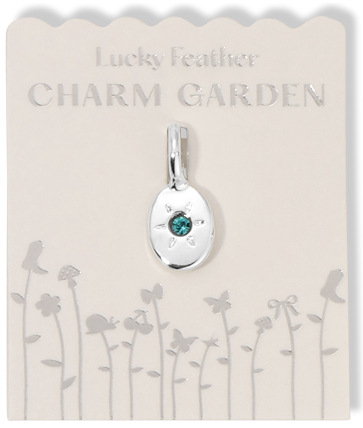 A silver charm with a turquoise stone is displayed on a card labeled 'Lucky Feather CHARM GARDEN'.