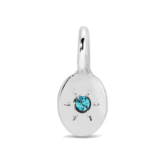 A silver charm with a blue gemstone.