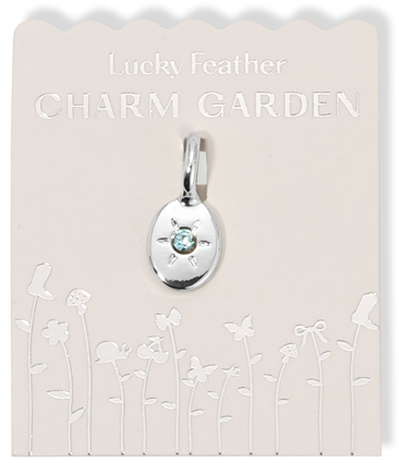 A 'Lucky Feather Charm Garden' pendant necklace on its packaging.