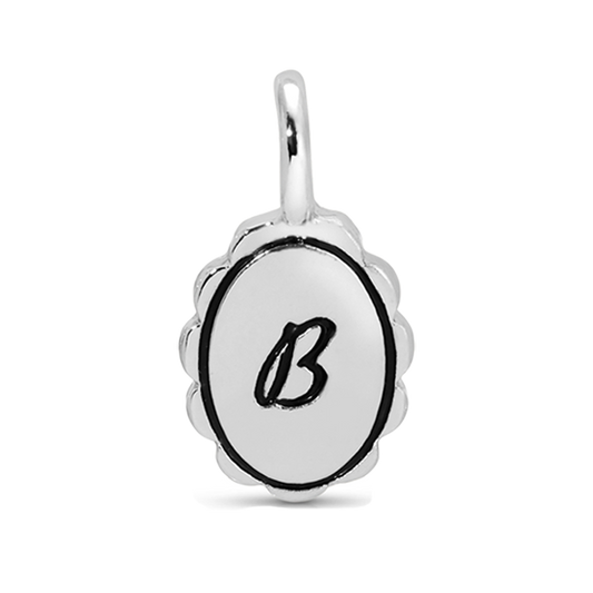 A silver pendant with a loop at the top features the letter 'B' in black on an oval surface.