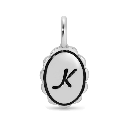 A silver charm with the letter K.