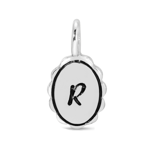 A silver charm pendant featuring the letter 'R' in black on a white oval background.