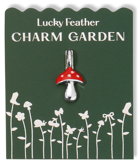 A mushroom charm on a green card labeled 'Lucky Feather CHARM GARDEN.'