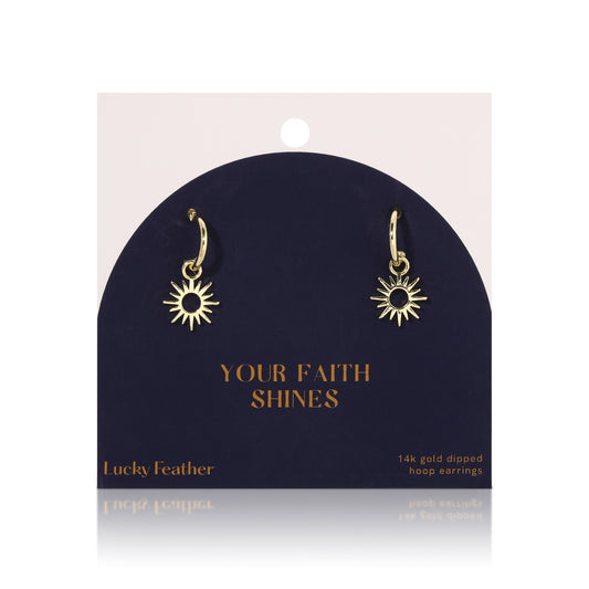 Gold-colored sun-shaped hoop earrings on a display card.