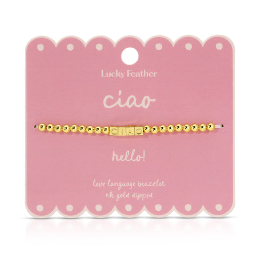 Ciao bracelet made of golden beads and letter beads on a pink card.