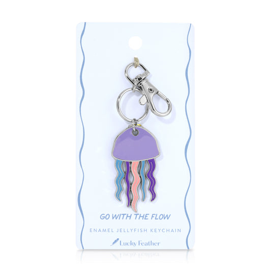 An enamel jellyfish keychain is displayed on its packaging.