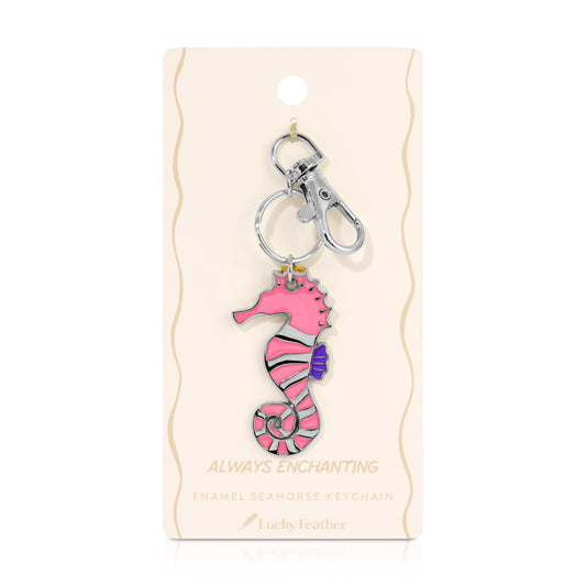 A pink seahorse keychain is displayed on its packaging.