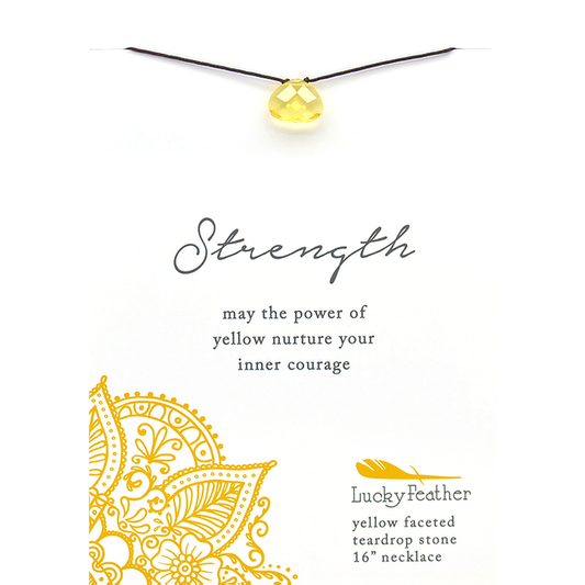A yellow teardrop pendant on a cord is presented on a card with the word 'Strength' and the phrase 'may the power of yellow nurture your inner courage.'