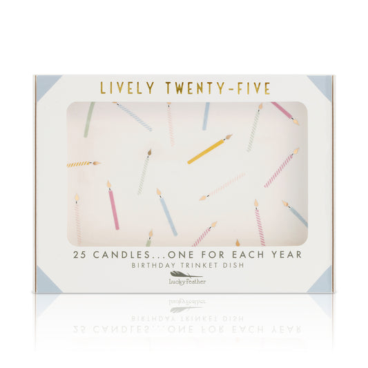 The image shows the packaging for a 'Lucky Feather' birthday trinket dish with 'Lively Twenty-Five' printed in gold and an illustration of 25 candles.