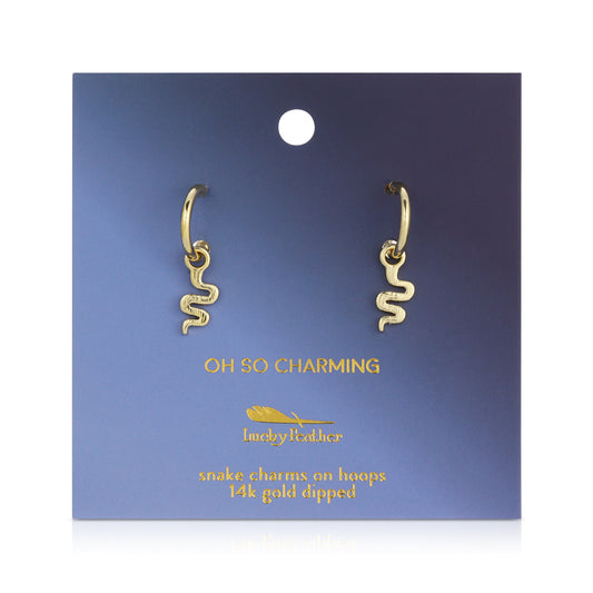 A pair of gold-colored snake charm earrings are displayed on a blue gradient card.