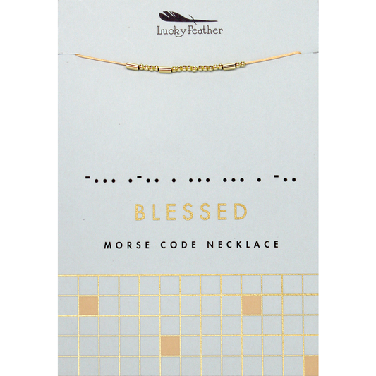 The image displays a 'Lucky Feather' necklace with gold beads representing 'Blessed' in morse code, on a card with the word 'BLESSED' written out and a grid pattern at the bottom.