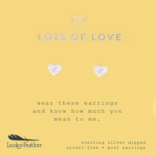 Two silver heart-shaped post earrings on a yellow card with the text 'LOTS OF LOVE' and 'Lucky Feather.'
