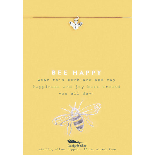 A bee charm necklace displayed on a yellow card with 'BEE HAPPY' message and a bee illustration.