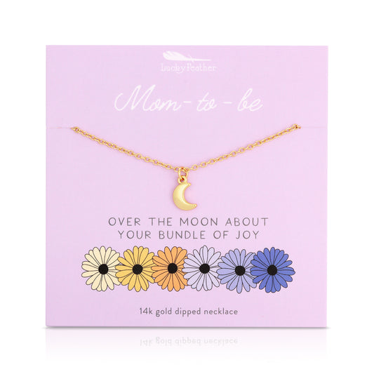 A 14k gold dipped necklace with a moon pendant on a lilac card with flowers and the phrase 'Mom-to-be'.