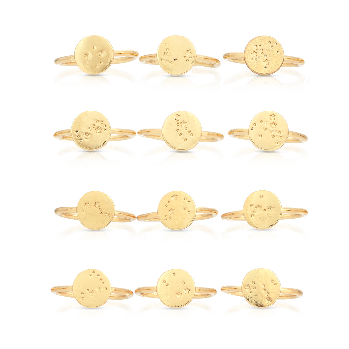 Twelve gold-colored rings with circular faces etched with star and circle designs are arranged in a grid on a white background.